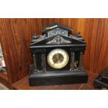 A FRENCH BLACK SLATE MANTLE CLOCK OF ARCHITECTURAL FORM