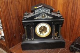 A FRENCH BLACK SLATE MANTLE CLOCK OF ARCHITECTURAL FORM