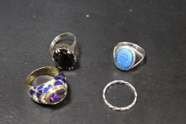 FOUR ASSORTED DRESS RINGS COMPRISING THREE SILVER EXAMPLES TOGETHER WITH A JOAN RIVERS GILT METAL