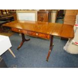 AN ANTIQUE MAHOGANY SOFA TABLE WITH BRASS CAPPINGS AND CASTORS