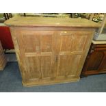 A LARGE PINE TWO DOOR CUPBOARD H-122 W-131 CM