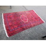 A LATE 19TH CENTURY PERSIAN WOOLLEN RUG 210 X 122 CM APPROX