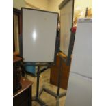 A PAIR OF REVOLVING WHITE BOARDS ON STANDS