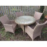 A MODERN CIRCULAR RATTAN PATIO TABLE AND FOUR CHAIRS