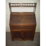AN ANTIQUE BUREAU WITH GALLERY SHELF AND CHIPPENDALE LATTICE STYLE DESIGN