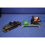 A VINTAGE PREIMA REMOTE CONTROL CAR TOGETHER WITH A CAST MONEY BANK