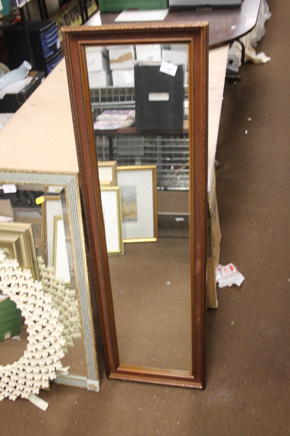 AN OBLONG FRAMED MIRROR