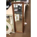 AN OBLONG FRAMED MIRROR