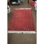 AN ANTIQUE WOOLEN RUG