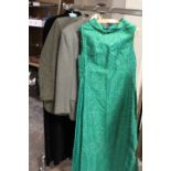 A VINTAGE BLACK VELVET CAPE WITH CONTRASTING RED LINING, TOGETHER WITH A VINTAGE GREEN LUREX EVENING