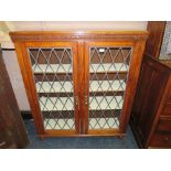 A VINTAGE OAK GLAZED TWO DOOR BOOKCASE W-106 CM