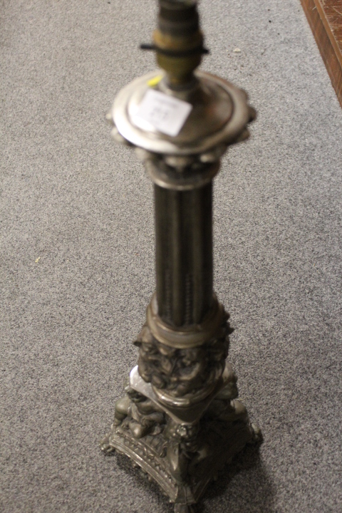 A LARGE CAST METAL LAMP BASE WITH REEDED COLUMN AND CHERUBIC DETAIL