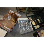 A TRAY OF ASSORTED DECANTERS AND A CLOCK TOGETHER WITH A SELECTION OF FLATWARE ETC
