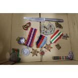 A BOX CONTAINING FOUR WWII MEDALS AND VARIOUS MILITARY ITEMS