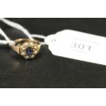 AN ANTIQUE SAPPHIRE AND SEED PEARL GOLD RING - MARKS INDISTINCT - APPROX 4 G