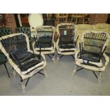 A SET OF FOUR MODERN WICKER ARMCHAIRS WITH STOOLS
