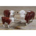 A BESWICK HEREFORD BULL, COW AND CALF TRIO