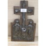 A CAST METAL RELIGIOUS SCENE MOUNTED ON A WOODEN PLAQUE