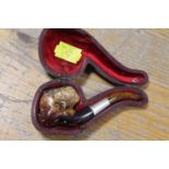 A VINTAGE MEERSCHAUM PIPE IN THE SHAPE OF A BLACK BOY IN A LEATHER COVERED CASE