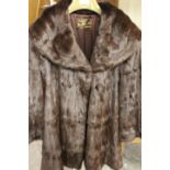 TWO VINTAGE FUR COATS COMPRISING A SWING STYLE BY JOHN DUNN & SONS OF DORKING AND SHORT BOLERO STYLE