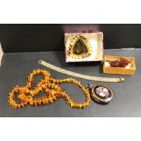 AN ANTIQUE ENAMEL GEMSET PENDANT LOCKET A/F, TOGETHER WITH A MODERN GRADUATED AMBER NECKLACES,