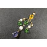 A GILT METAL PENDANT SET WITH SEED PEARLS AND COLOURED STONES