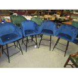 A SET OF FOUR DARK BLUE UPHOLSTERED STOOLS