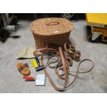 A VINTAGE WICKER BASKET AND CONTENTS TO INCLUDE HORSE TACK