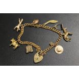 A HALLMARKED 9CT GOLD CHARM BRACELET AND CHARMS, TO INCLUDE EQUESTRIAN EXAMPLES - APPROX WEIGHT 23.9