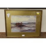 A GILT FRAMED AND GLAZED WATERCOLOUR OF TWO FISHERMEN IN A BOAT ON THE SHORELINE, SIGNED LOWER RIGHT