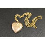 A 9CT GOLD BACK AND FRONT LOCKET ON CHAIN