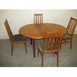 A RETRO TEAK DANISH EXTENDING DINING SET WITH 4 CHAIRS