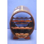 AN OAK OVAL SHAPED BRASS BOUND WINE RACK H 56 CM W 38 CM D 33 CM