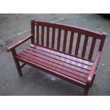 A SOLID WOODEN GARDEN BENCH