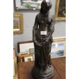 A BRONZED EFFECT STANDING LADY STATUE