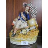 A 19TH CENTURY STAFFORDSHIRE FIGURE OF A SCOTSMAN