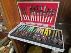 A CASED VINTAGE RETRO CUTLERY SET WITH MULTICOLOURED HANDLES TOGETHER WITH A CANTEEN OF CUTLERY (2)