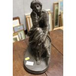 A BRONZE EFFECT SEATED LADY STATUE