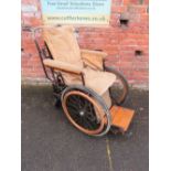 A VINTAGE INVALID CARRIAGE WITH WOODEN BANDED WHEELS