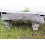 A CURVED CONCRETE GARDEN BENCH