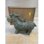 A VINTAGE BRONZE ORIENTAL CANDLE HOLDER IN THE SHAPE OF A MYTHICAL ANIMAL