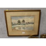 A FRAMED AND GLAZED WATERCOLOUR OF A POOLSIDE COTTAGE INDISTINCTLY SIGNED LOWER RIGHT