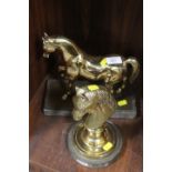 A BRASS MODEL OF A HORSE TOGETHER WITH A BRASS STUDY OF A HORSES HEAD