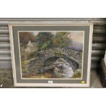 A FRAMED AND GLAZED OIL ON BOARD OF A STONEWALL BRIDGE OVER A STREAM SIGNED IN RED LOWER RIGHT