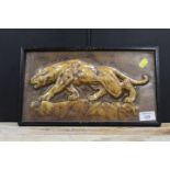 AN EARLY 20TH CENTURY GLAZED POTTERY TILE DEPICTING A JAGUAR IN PERIOD BLACK FRAME