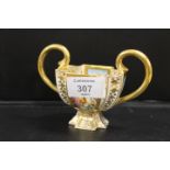 A HAND PAINTED AND GILT FLORAL SHAPED TWIN HANDLED QUATREFOIL CUP