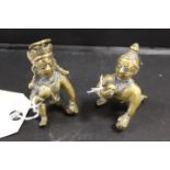 A PAIR OF SMALL BRASS AZTEC STYLE BALL PLAYERS
