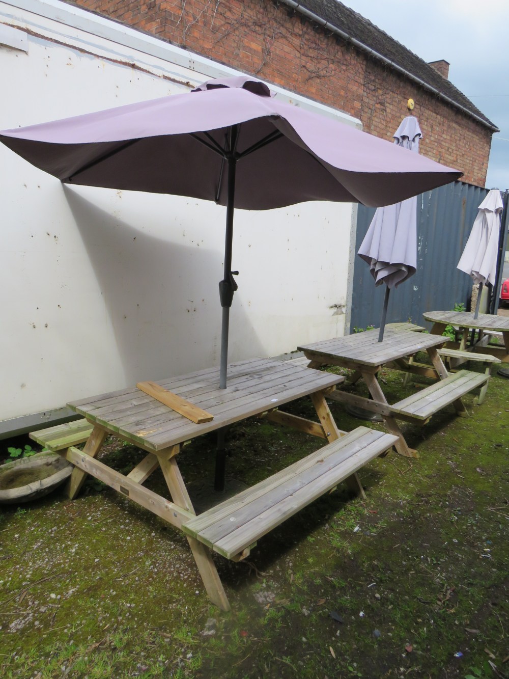 A ROWINSON WOODEN GARDEN / PATIO TABLE WITH PARASOL AND STAND