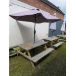 A ROWINSON WOODEN GARDEN / PATIO TABLE WITH PARASOL AND STAND