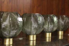A SET OF FOUR MODERN GLASS CANDLE HOLDERS